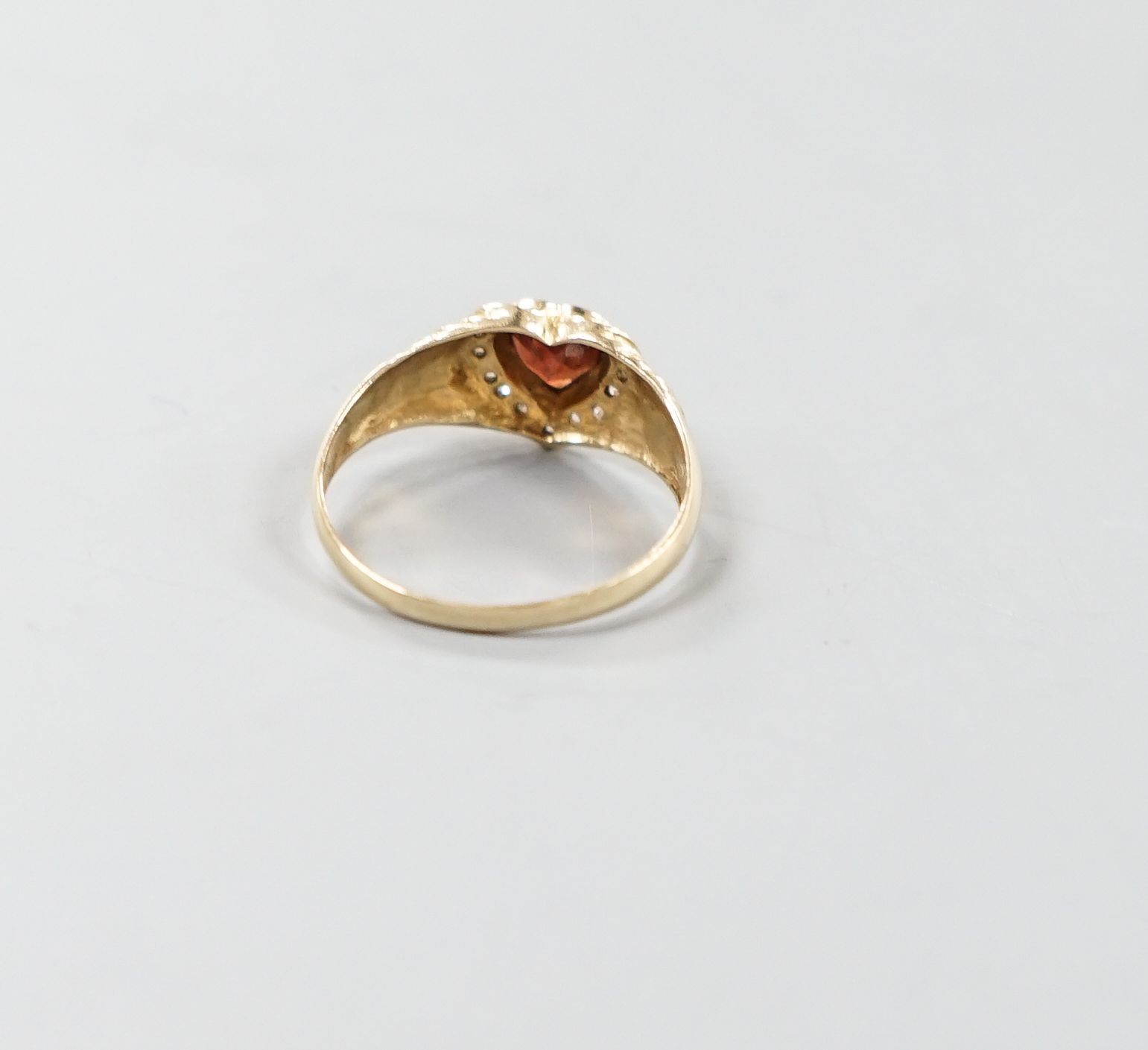 A 14k, hearts shaped paste and diamond chip set dress ring, size N/O, gross weight 2.1 grams.